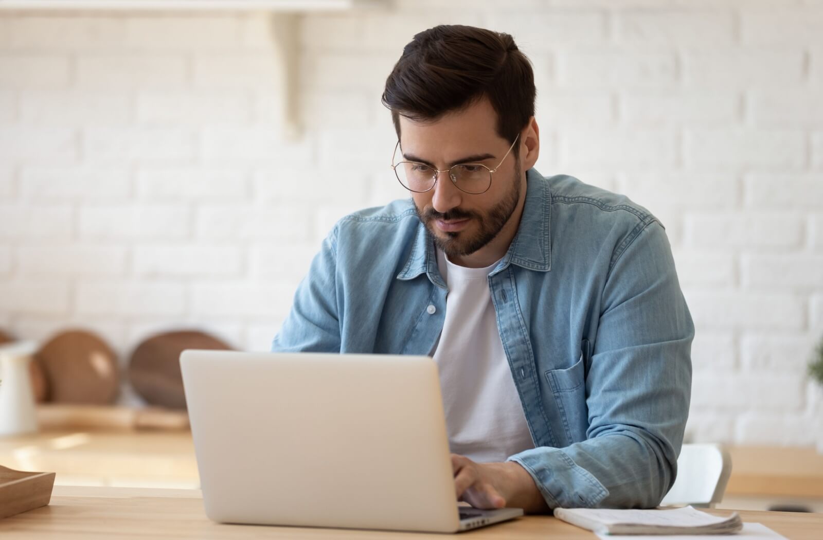 Man sitting at the computer researching health insurance.
