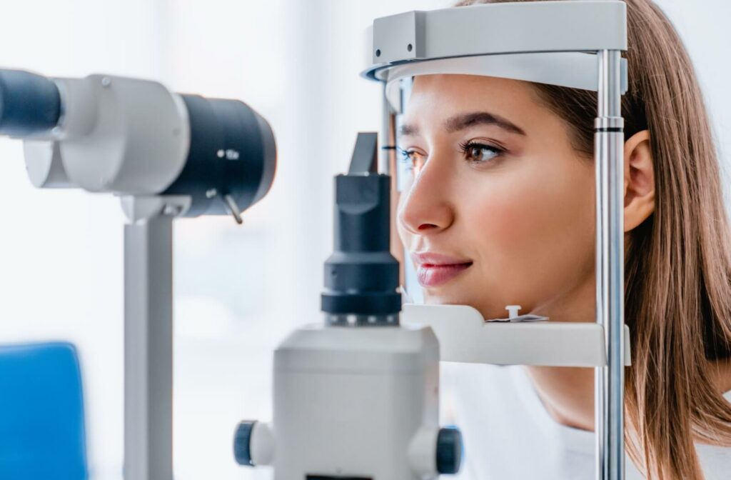A female patient receiving a slit lamp exam during her regular eye exam.