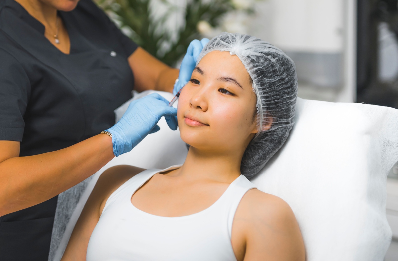 A person getting botox injected into their forehead to smooth out wrinkles.